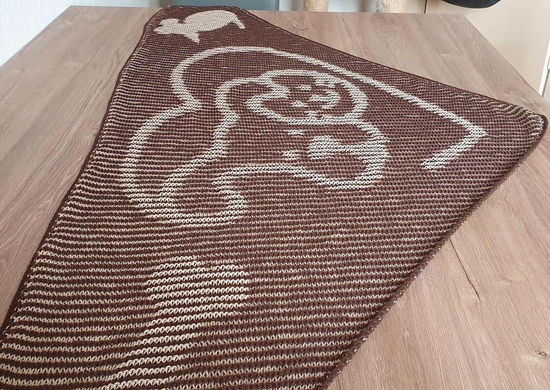 Triangular brown and beige knitted shawl with elephant motif