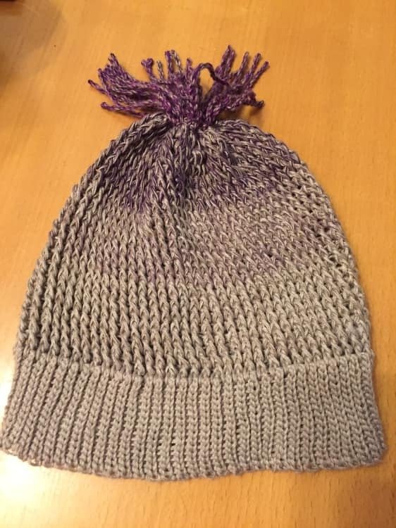 Gehäkelte Kinder‑Mütze hellgrau mit lila Farbverlauf und Quaste