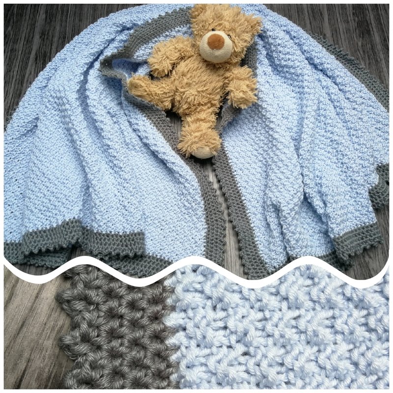 Hellblaue gestrickte Babydecke mit grauem Rand und kleinem braunen Teddybär auf dunklem Holzuntergrund