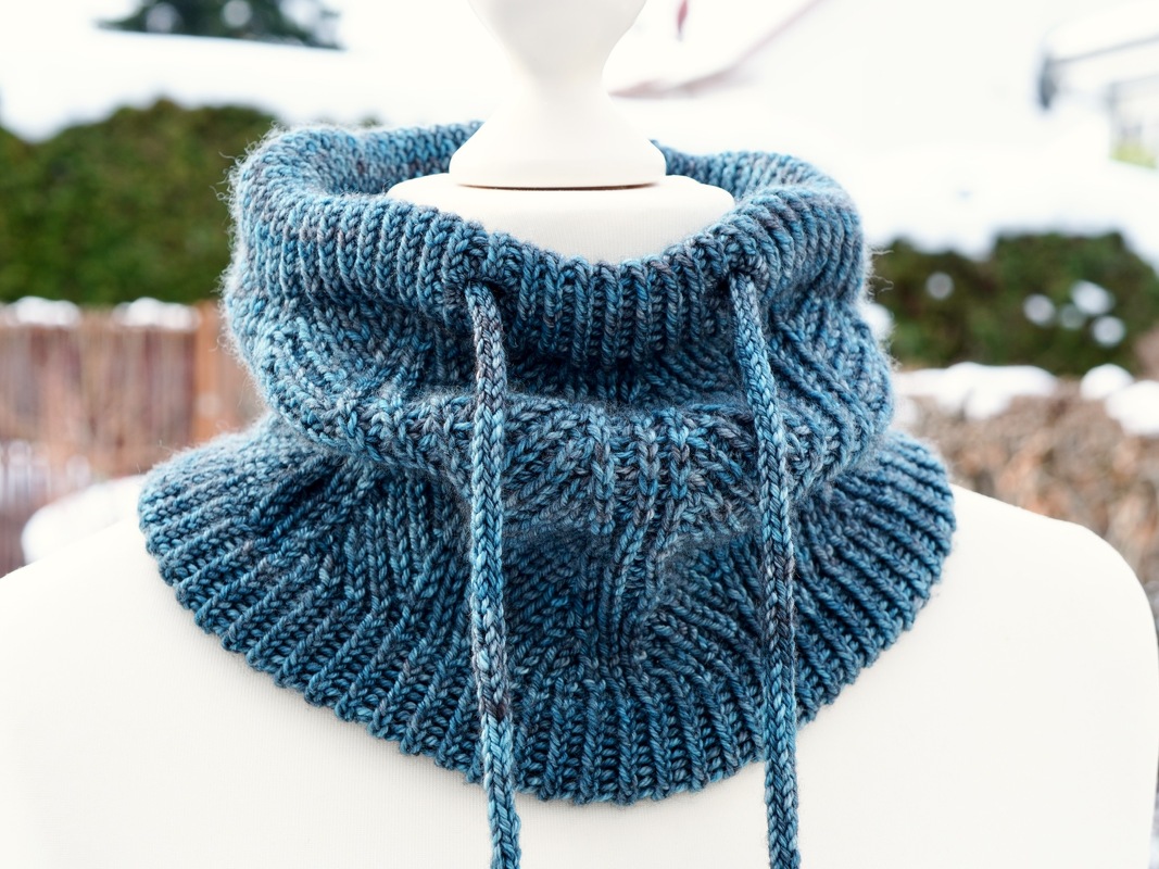 blue ribbed knit cowl with drawstrings on a mannequin