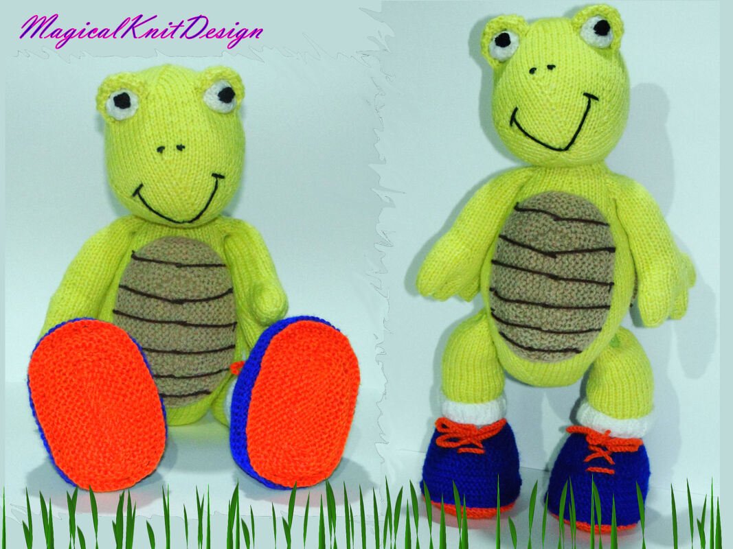 Two hand-knitted lime-green amigurumi turtles, one seated with orange-and-blue booties and one standing with blue shoes and orange laces.