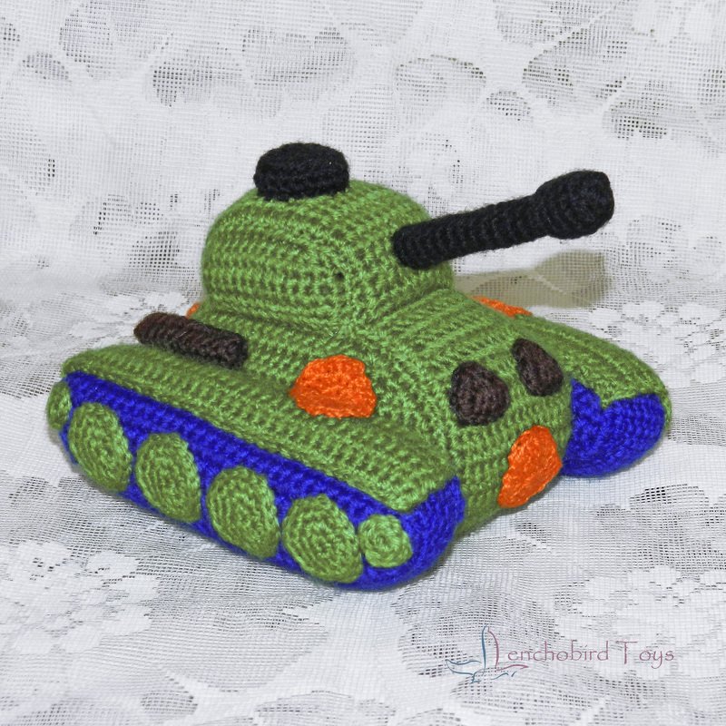 Hand-crocheted green tank amigurumi with blue tracks and black barrel