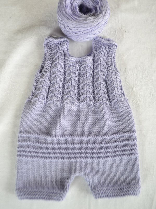 Gestrickter fliederfarbener Baby-Strampler mit Zopfmuster