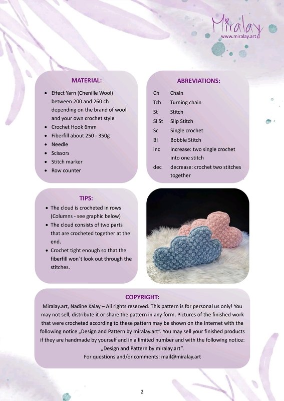Two fluffy cloud-shaped crochet pillows in pastel blue and pink on a white faux-fur surface.
