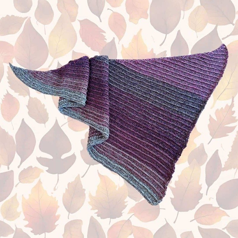 Triangular crocheted shawl with purple-to-gray gradient and diagonal ribbed texture