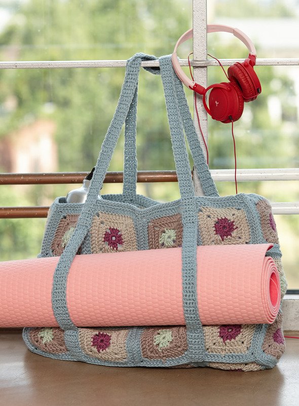 Gehäkelte Granny-Square-Tasche mit rosa Yogamatte und roten Kopfhörern