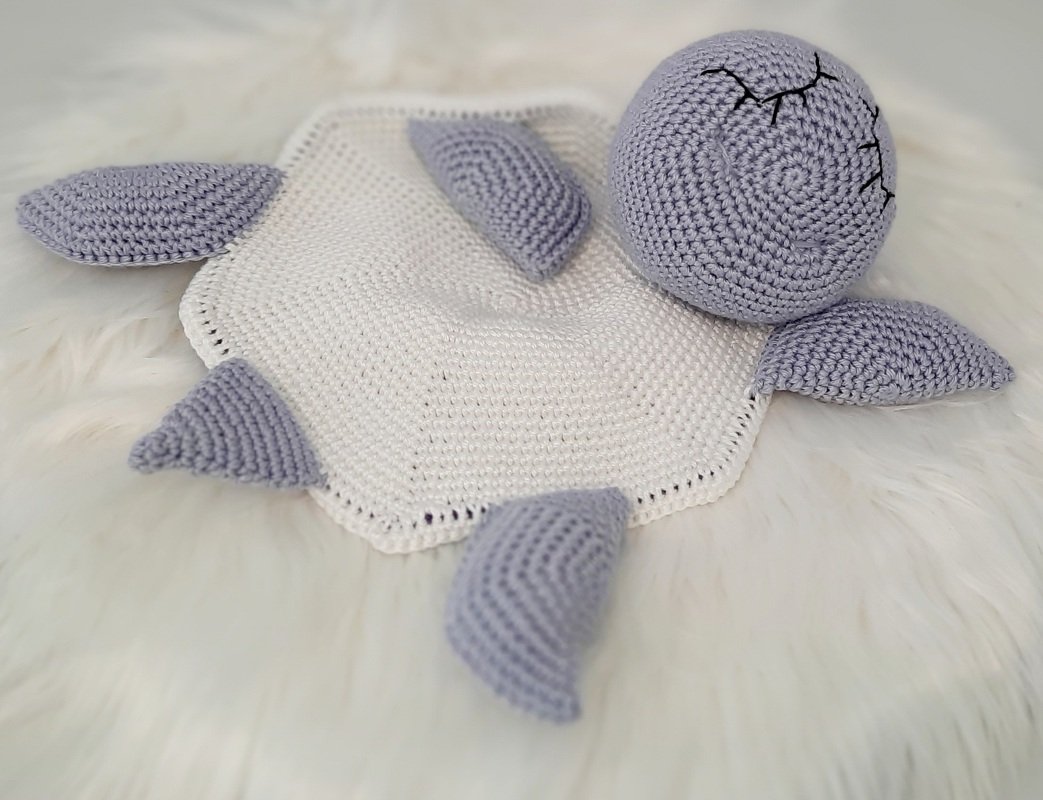 Pastel crochet turtle lovey with white hex blanket and lilac head and limbs
