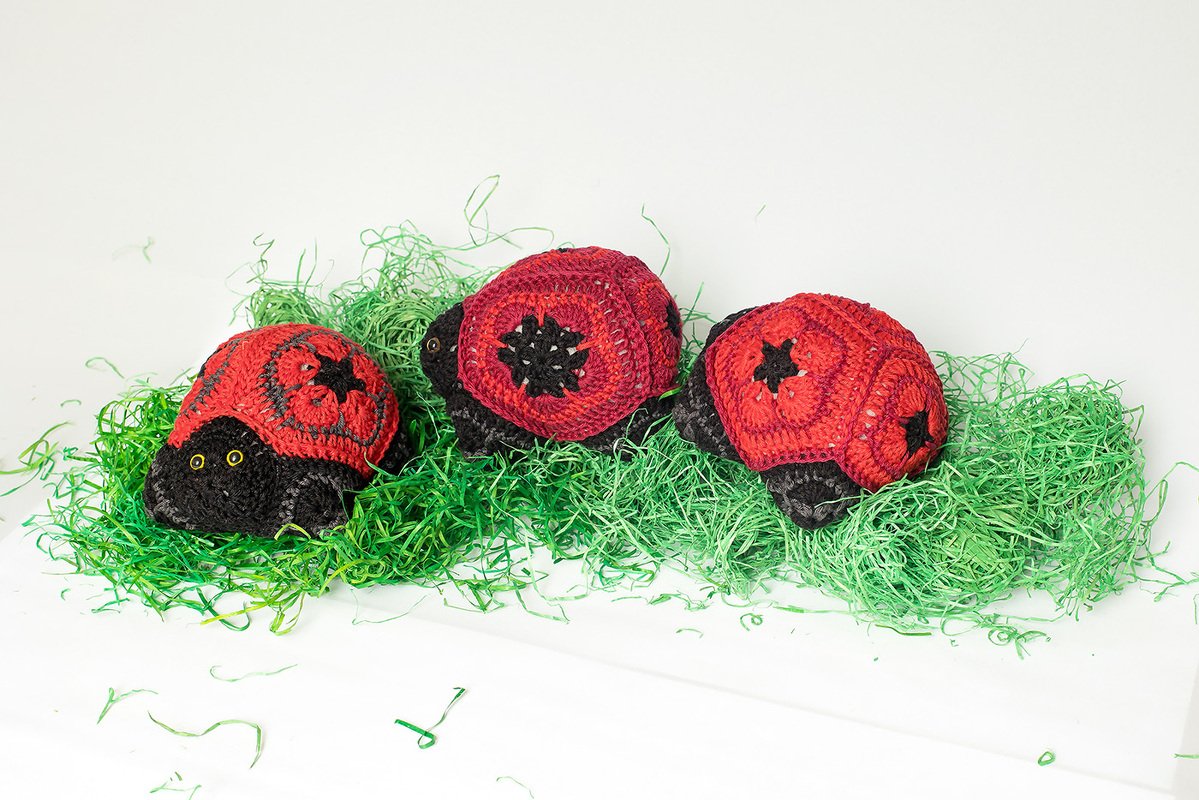 Three small amigurumi ladybugs showing African flower motif shells
