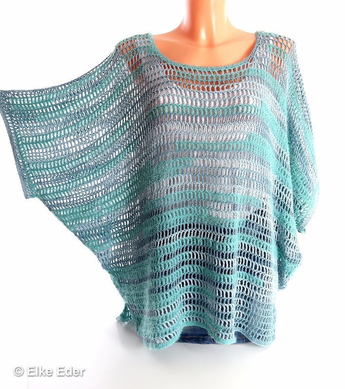 Light blue and teal striped open-knit crochet tunic on a mannequin