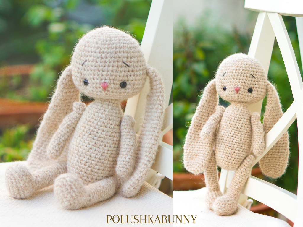 Beige crocheted amigurumi bunny with long floppy ears and a pink nose on a white chair