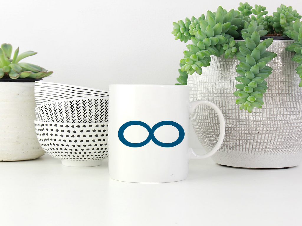 Weiße Tasse mit petrolfarbenem Unendlichkeitssymbol, links gemusterte Schalen, rechts Sukkulente in einem Topf