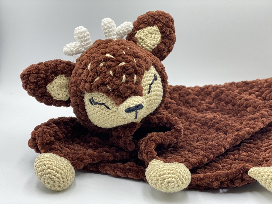 Brown crochet fawn snuggle blanket with cream face, embroidered eyes, antlers and plush textured blanket