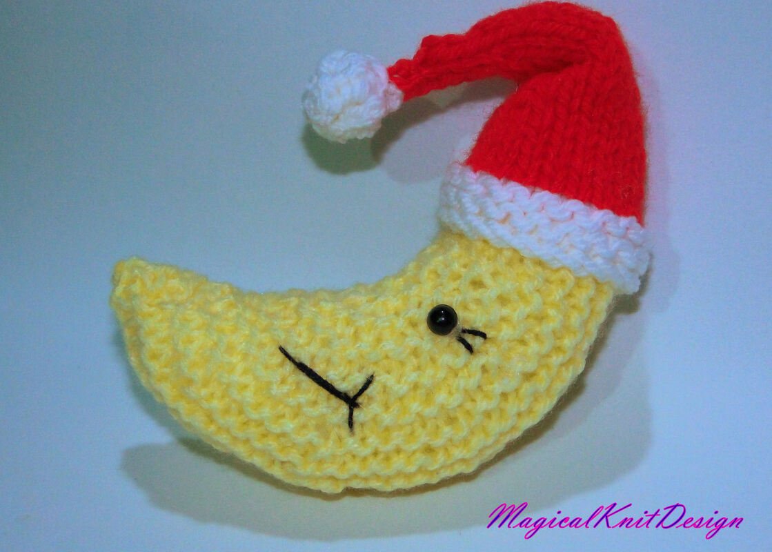 Textured yellow knitted crescent moon plush with embroidered face and Santa hat