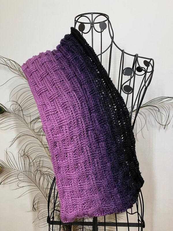 Purple-to-black ombre crochet cowl with basketweave texture draped over a wire dress form
