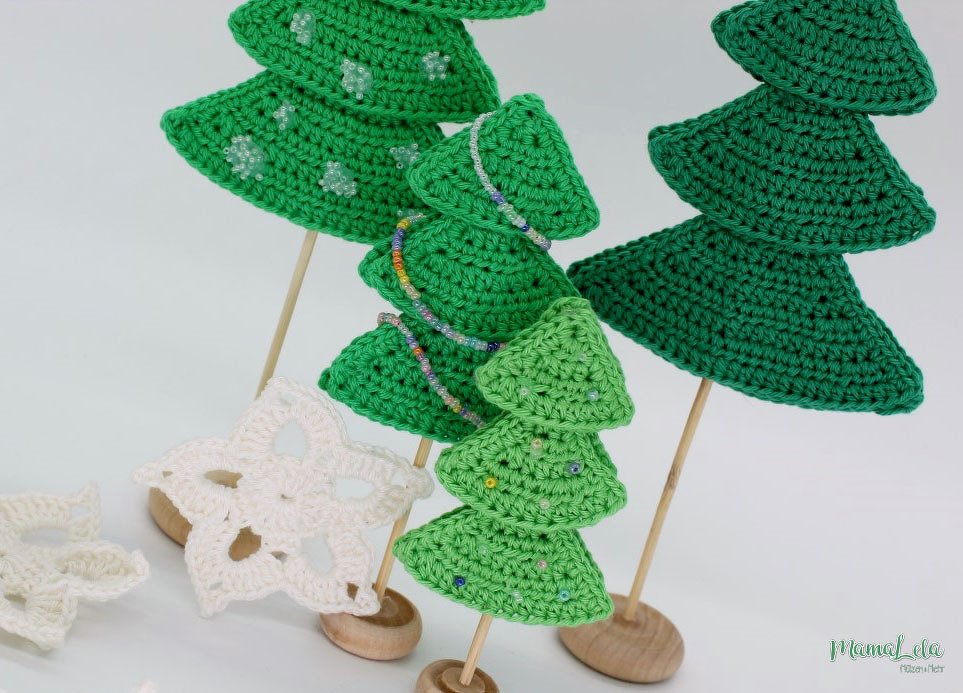 Kleine schnell gehäkelte Tannenbäume auf Holzständern mit Perlen