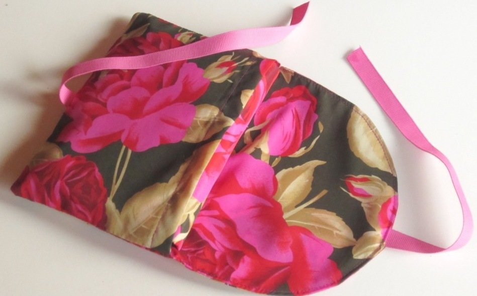 Flach liegende Stoff-Einkaufstasche mit großem pinken Blumenmuster und rosa Trägern