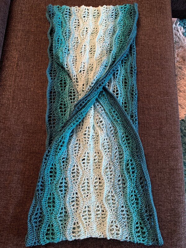 Teal-to-cream crocheted infinity cowl with leaf-lace stitch and center twist