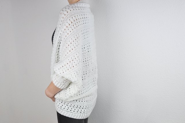 White crochet long shrug with openwork lace stitch and dolman sleeves, back and side view