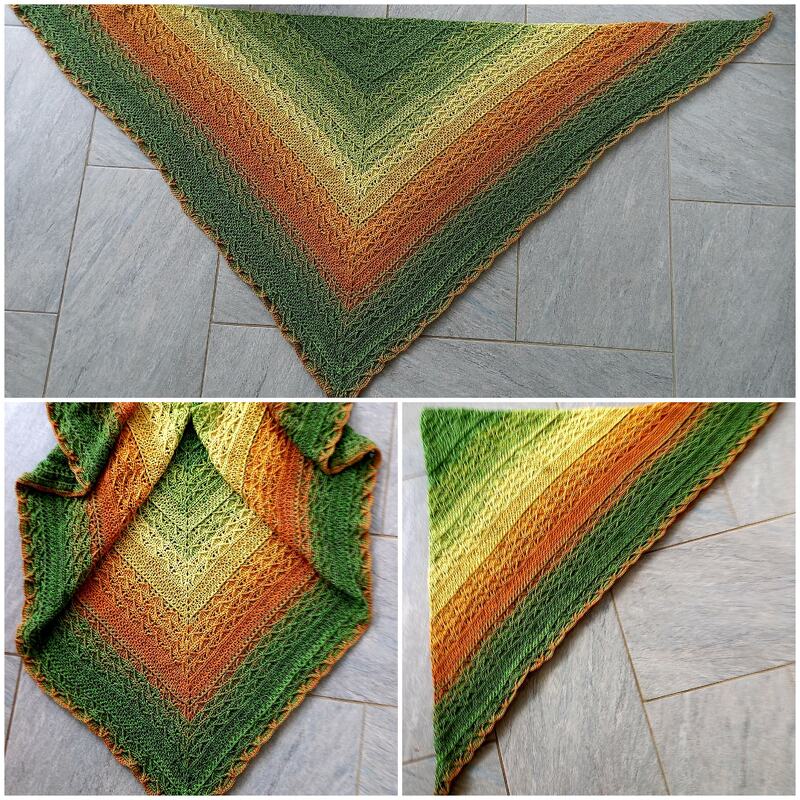 Gehäkeltes Dreieckstuch in Grün-, Gelb- und Orangetönen auf grauem Boden