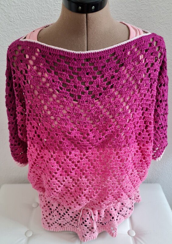 Gehäkelte Damen-Tunika in Pink- bis Beerenverlauf mit offenem Lochmuster auf Schneiderpuppe