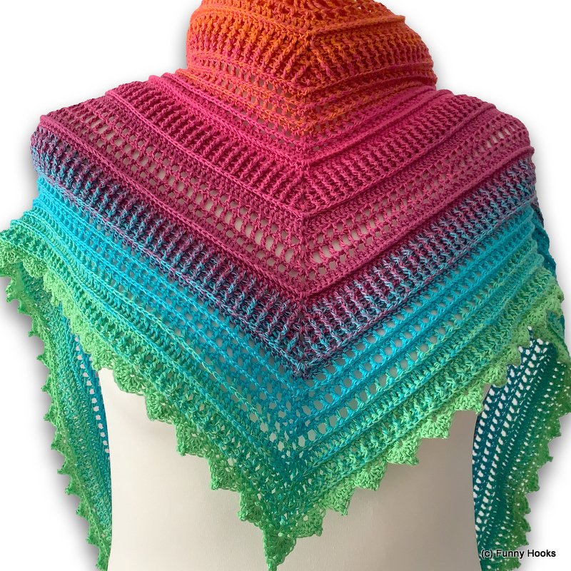 Triangular crochet shawl on a dress form, gradient orange to green with lace panels and scalloped edging