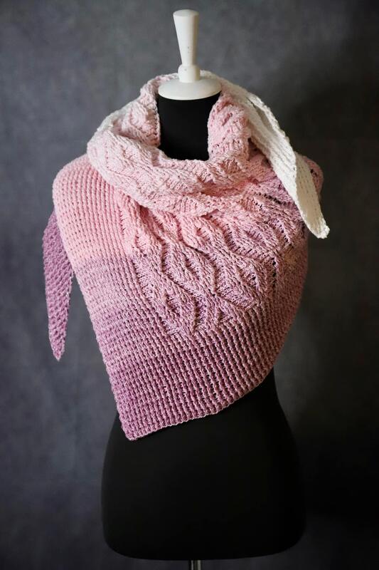 Ombre crochet triangle shawl in pale pink to mauve with raised cable and textured stitches, shown on a dress form.
