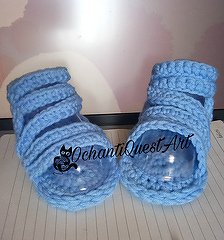 Pair of light blue crocheted baby sandals on clear inserts