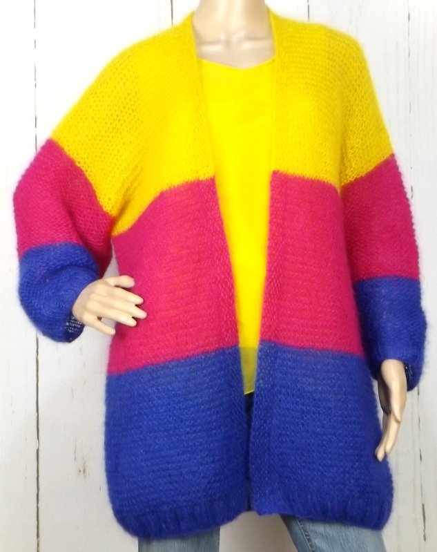 Oversize-Strickjacke mit Farbblöcken (Gelb, Pink, Blau) an einer Schaufensterpuppe