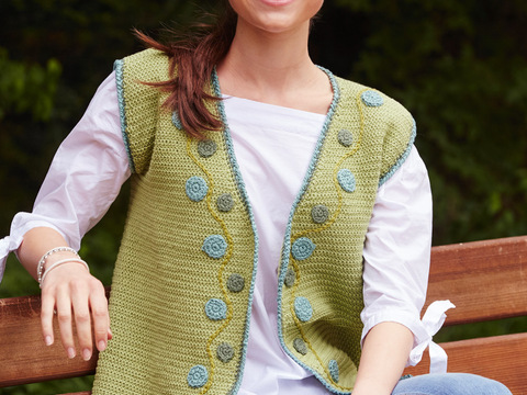 Grüne, gehäkelte Weste mit aufgenähten, gehäkelten Ornamenten