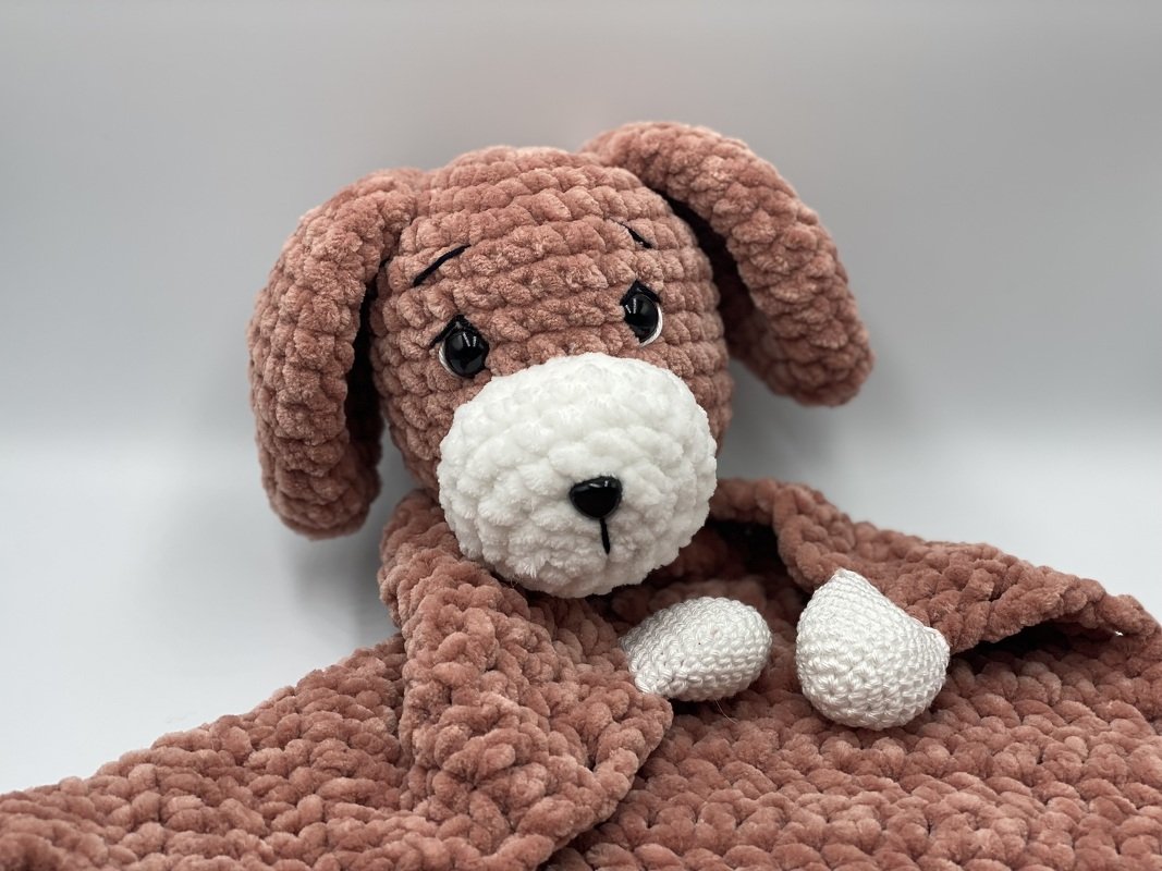plush crocheted dog lovey with floppy ears and matching dusty-rose and white snuggle blanket
