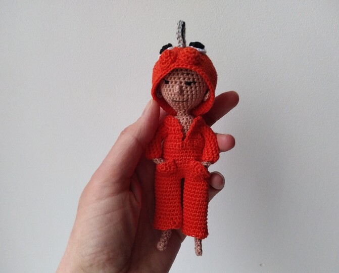 Doll with chainsaw and eyes on her hoodie, crochet amigurumi