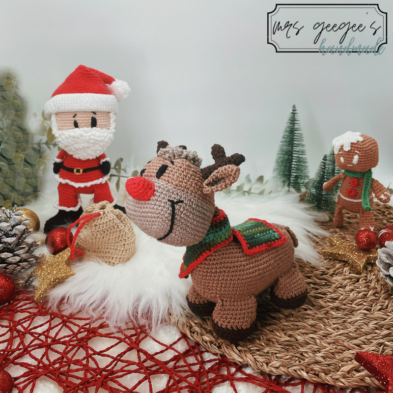 Amigurumi crochet display of Santa Claus, a red-nosed reindeer, and a gingerbread man.