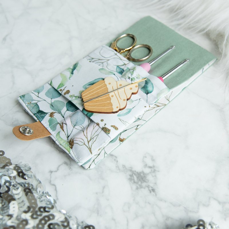Eucalyptus print crochet hook organizer pouch with crochet hooks, gold scissors and wooden stitch marker
