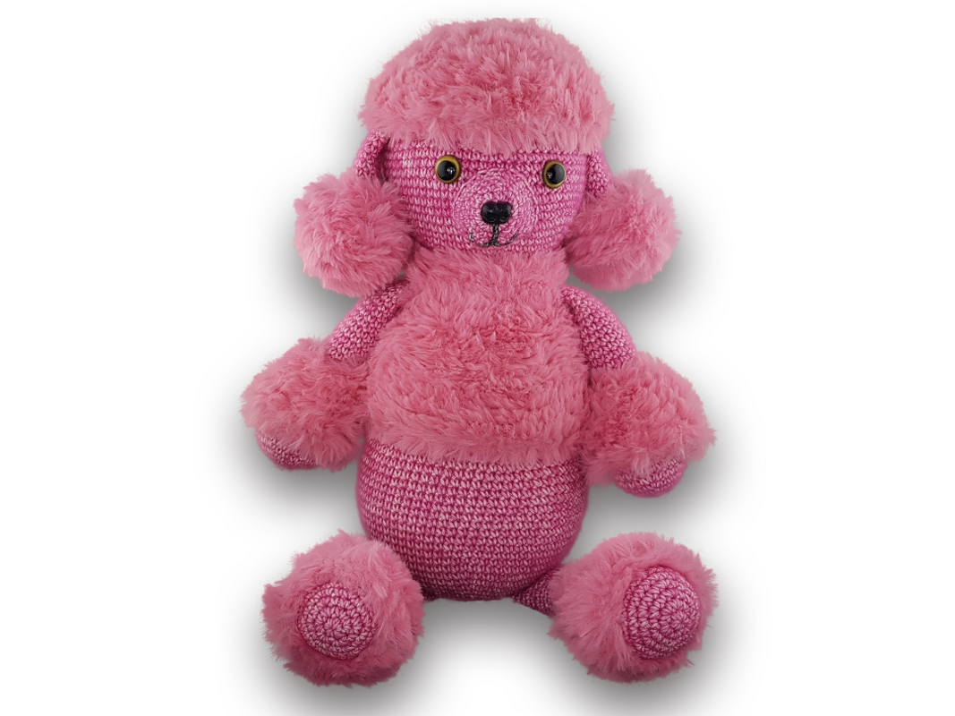Pink crocheted poodle amigurumi with fluffy mane and paw accents, sitting on a white background.