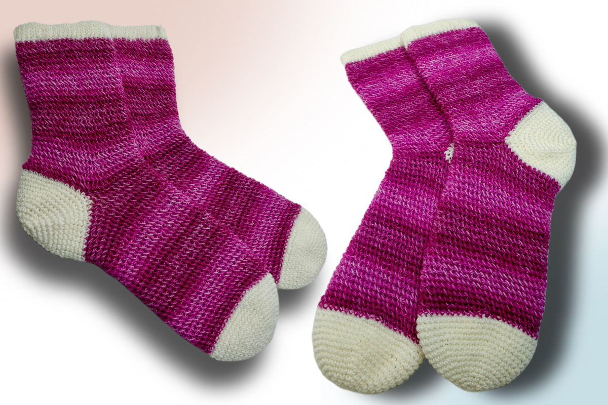 Pair of pink gradient crochet ankle socks with cream toes, heels, and cuffs
