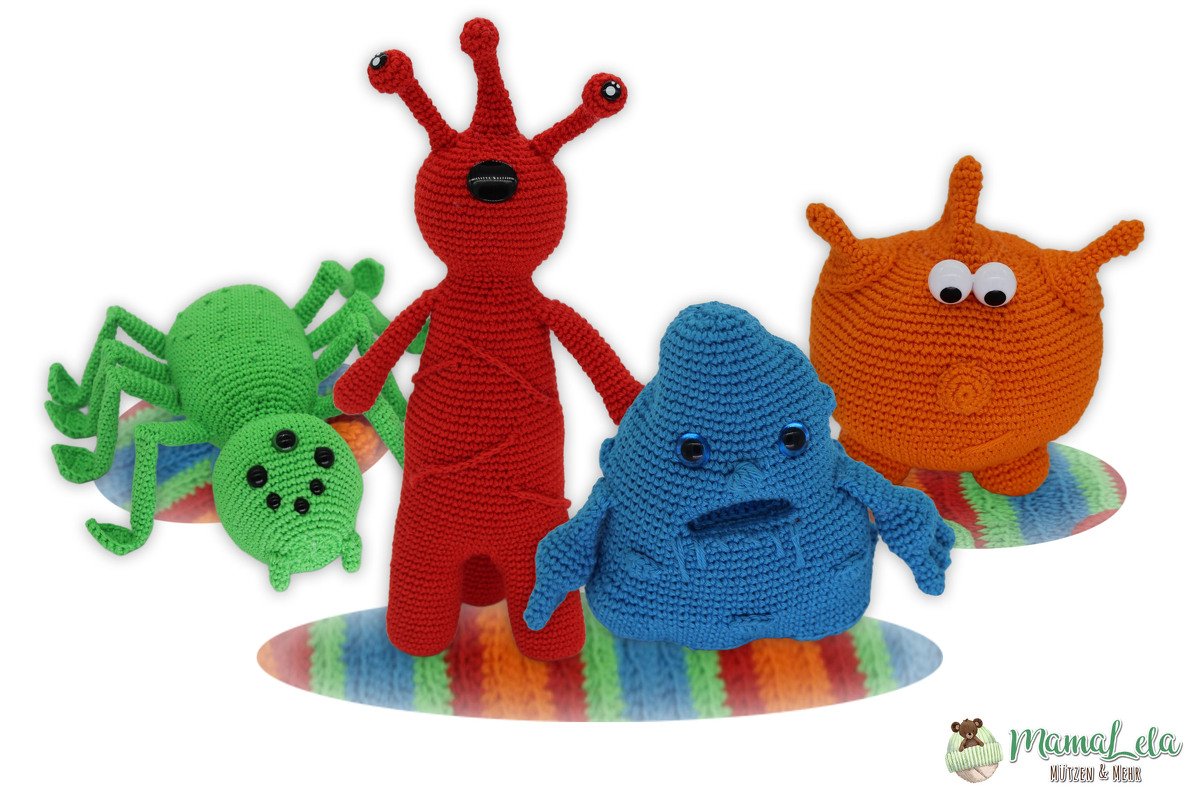 Vier gehäkelte Amigurumi-Figuren (grün, rot, blau, orange) auf gestreiften Unterlagen vor weißem Hintergrund.