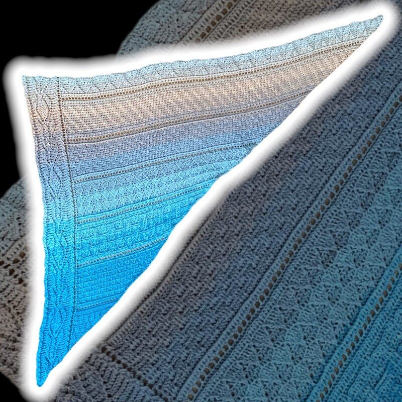 Triangular crochet shawl with cream-to-aqua ombré, textured panels, eyelet rows and braided border