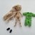 Tiny pose-able doll is wearing playsuit and slippers