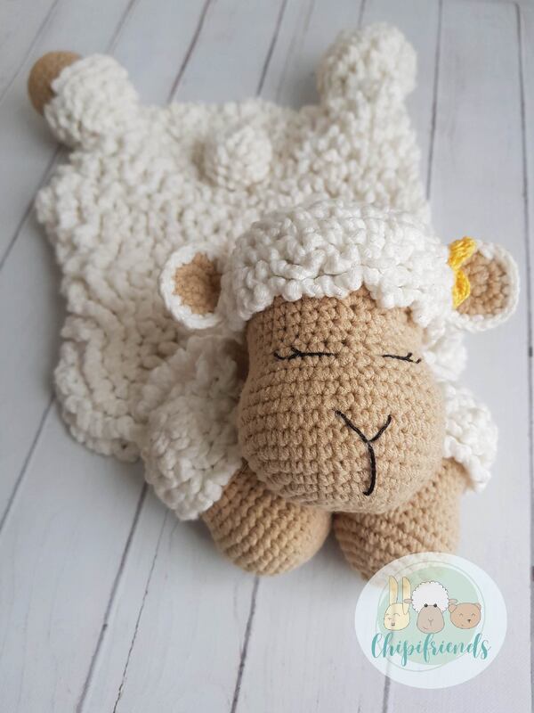 Crocheted lamb lovey with beige amigurumi head and fluffy white snuggle blanket