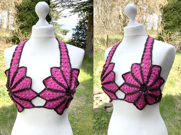 Mannequin trägt gehäkeltes Top mit pinken Blütenapplikationen und schwarzer Umrandung