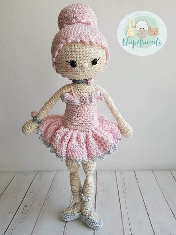 Pink and beige crocheted ballerina amigurumi doll with ruffled tutu and bun hairstyle