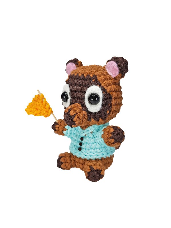 Braun-beige gehäkelte Amigurumi-Figur mit blauem Hemd und gelber Fahne