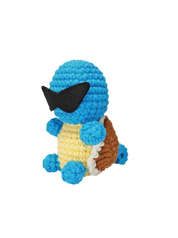 Gehäkelte blaue Amigurumi-Schildkröte mit gelbem Bauch, braunem Panzer und schwarzer Sonnenbrille