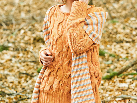 Ockerfarbener Pullover im Zopfmuster und passendem Streifenschal