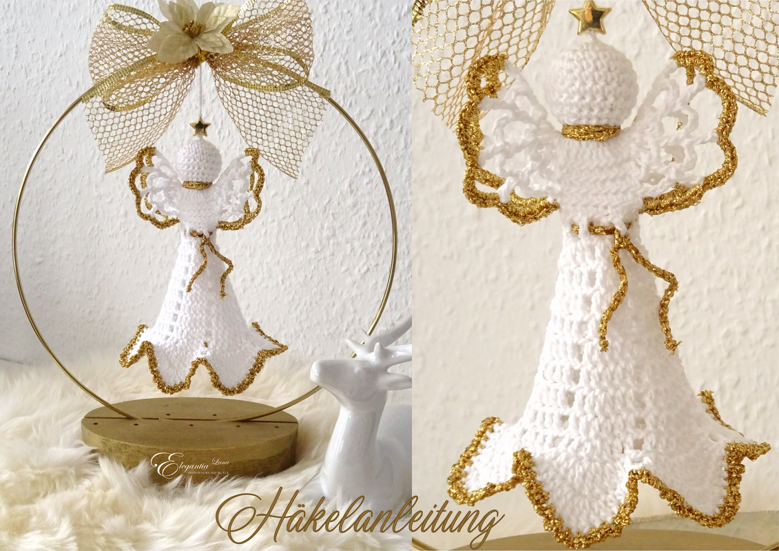 Gehäkelter weißer Engel mit goldenen Flügelkanten, aufgehängt in einem goldenen Ring mit Schleife und Stern, auf flauschigem Untergrund.