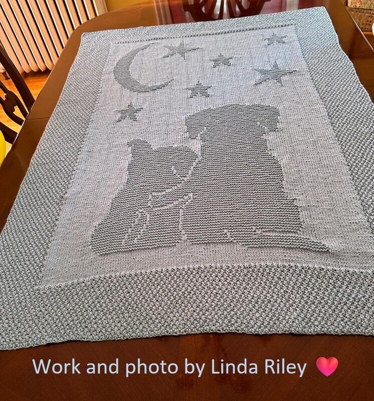 Grey knitted baby blanket with cat and dog silhouettes, crescent moon and stars