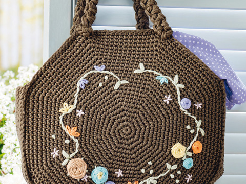 Olivgrüne Häkeltasche mit aufgestickten bunten Blütenranken