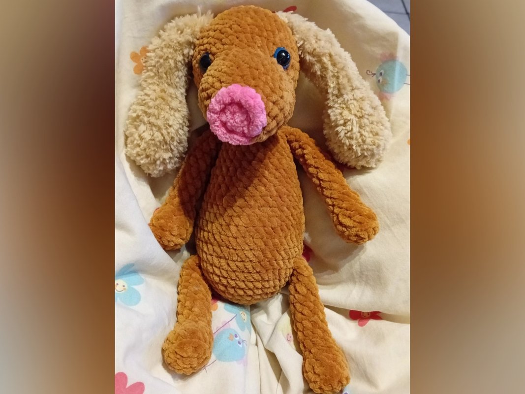 Gehäkelter brauner Amigurumi-Hund mit rosa Schnauze und hellen Schlappohren