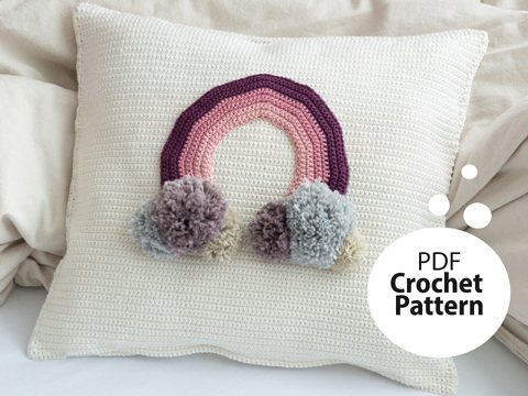 Crochet pattern cushion with rainbow appliqué for the children's room
