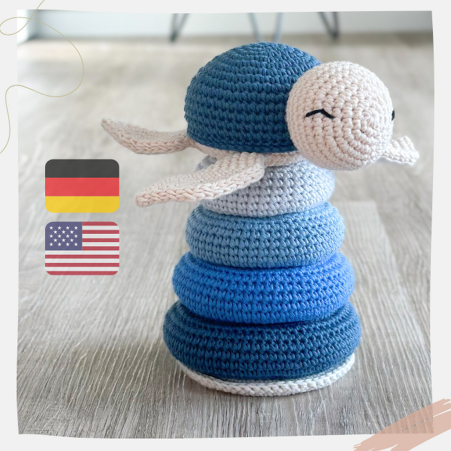 Handmade crocheted turtle stacking toy with five blue gradient rings and a light beige head on a light wooden floor.